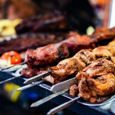 Barbecue grill meat at street food market. Fresh cooking delicious bbq beef at traditional fair